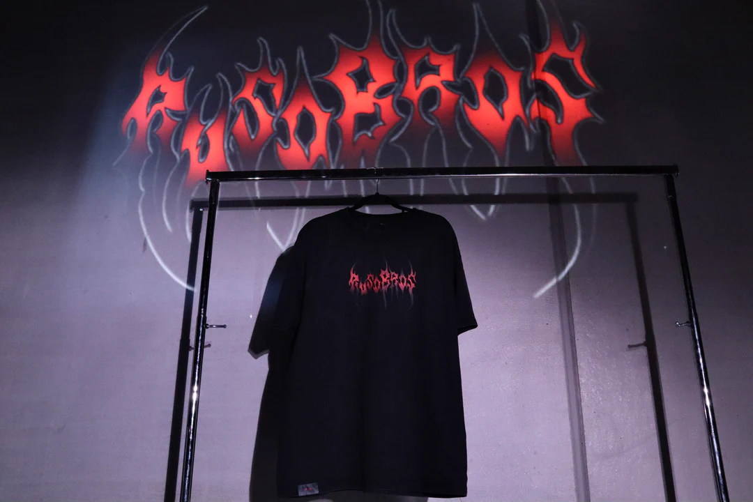 Ruso Bros tee hanging in front of glowing logo